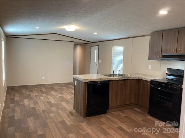 kitchen with kitchen peninsula, ventilation hood, black appliances, dark hardwood / wood-style floors, and lofted ceiling