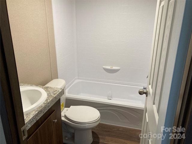 full bathroom featuring wood-type flooring, vanity, toilet, and  shower combination