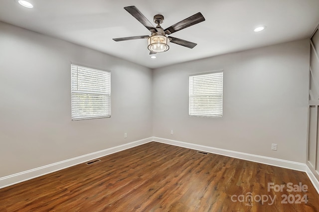 unfurnished room with ceiling fan and dark hardwood / wood-style flooring