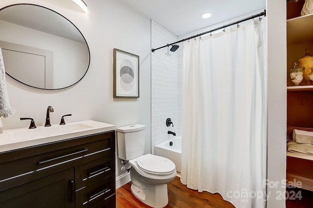 full bathroom with shower / bath combination with curtain, vanity, hardwood / wood-style flooring, and toilet