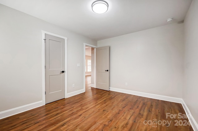 unfurnished bedroom with hardwood / wood-style flooring