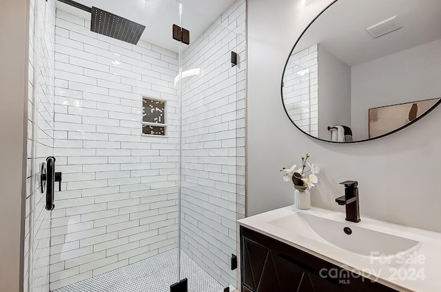 bathroom featuring vanity and a shower with shower door