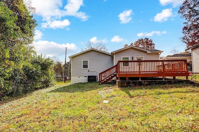 rear view of property with a yard, a deck, and cooling unit