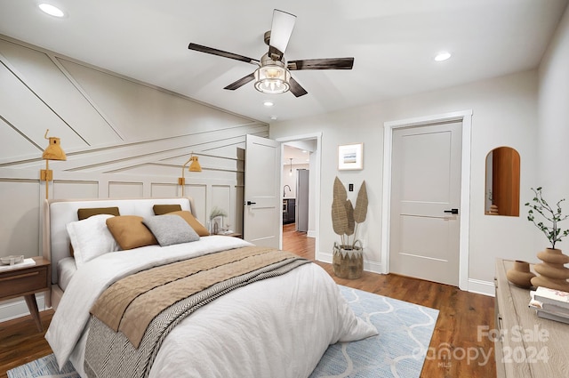 bedroom featuring ceiling fan and dark hardwood / wood-style floors