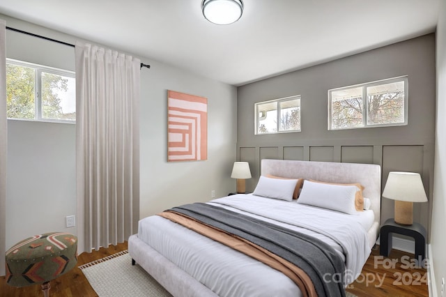 bedroom featuring hardwood / wood-style floors and multiple windows