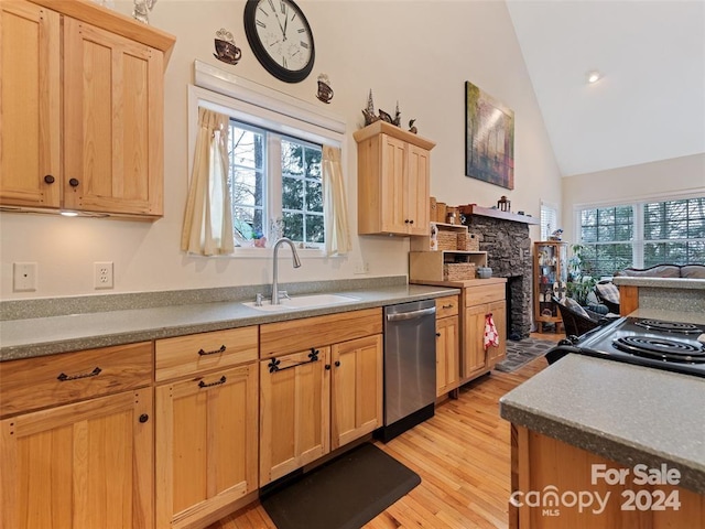 kitchen featuring sink, dishwasher, light hardwood / wood-style flooring, vaulted ceiling, and light brown cabinetry