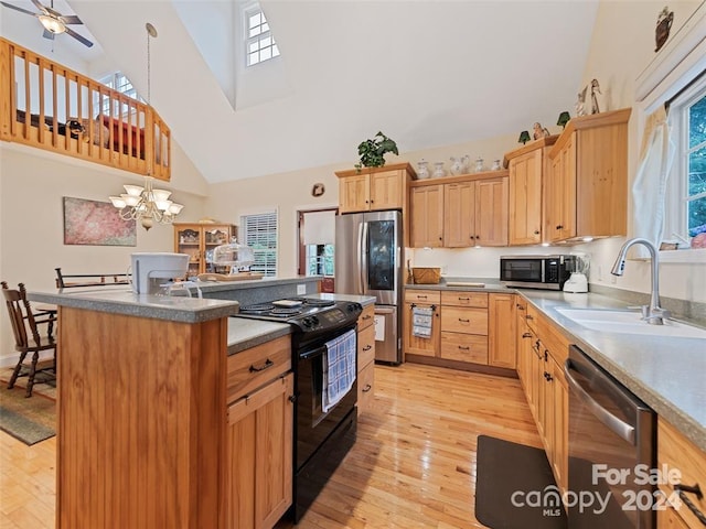 kitchen with a center island, high vaulted ceiling, sink, light hardwood / wood-style flooring, and appliances with stainless steel finishes