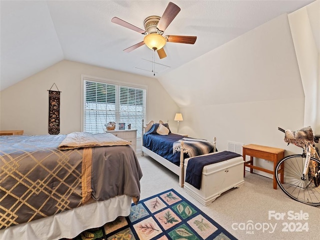 carpeted bedroom with vaulted ceiling and ceiling fan