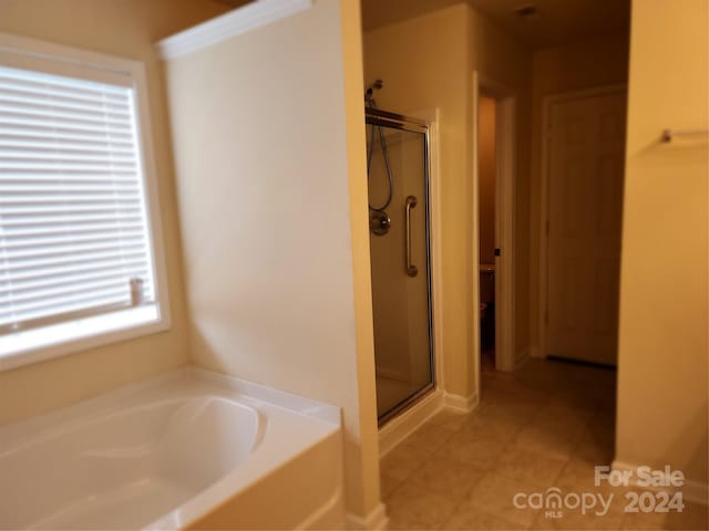 bathroom featuring plus walk in shower and tile patterned floors