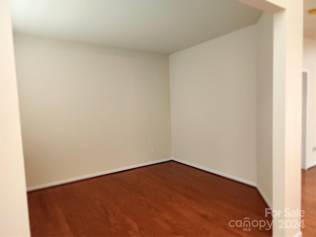 empty room with dark hardwood / wood-style floors