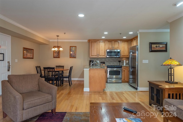 kitchen featuring pendant lighting, an inviting chandelier, light hardwood / wood-style floors, and appliances with stainless steel finishes