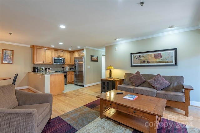 living room featuring ornamental molding and light wood-type flooring