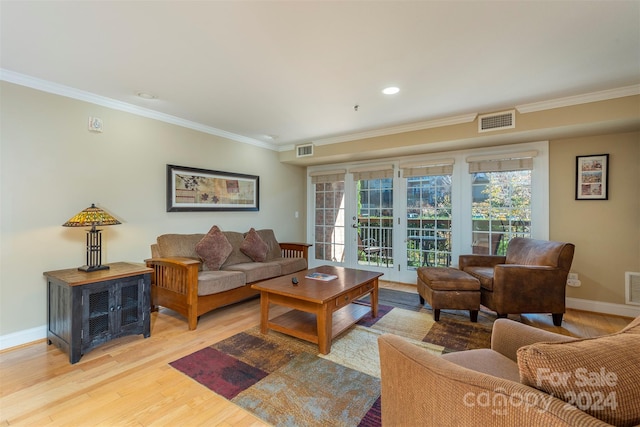 living room featuring french doors, light hardwood / wood-style flooring, and ornamental molding