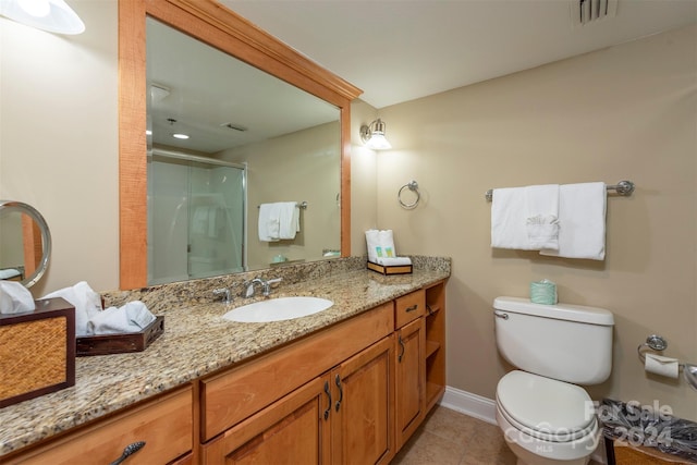 bathroom with tile patterned flooring, vanity, toilet, and a shower with shower door