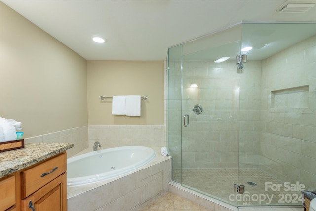 bathroom with tile patterned floors, vanity, and independent shower and bath