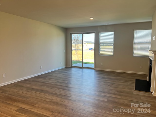 unfurnished living room with dark wood-type flooring