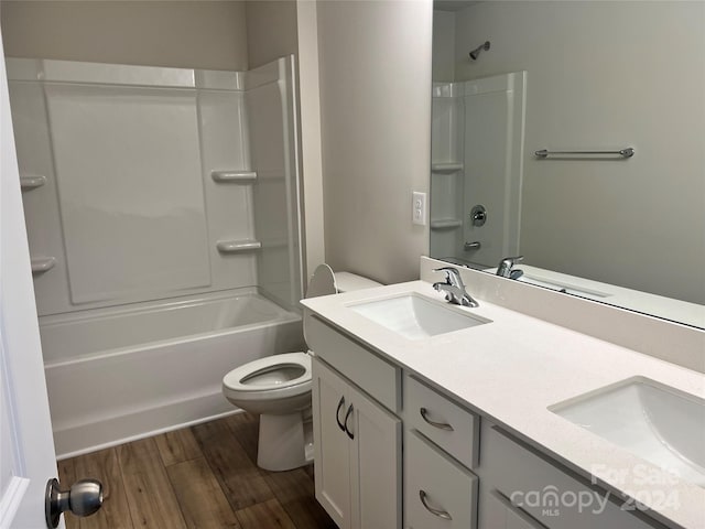 full bathroom featuring hardwood / wood-style floors, vanity, toilet, and shower / tub combination