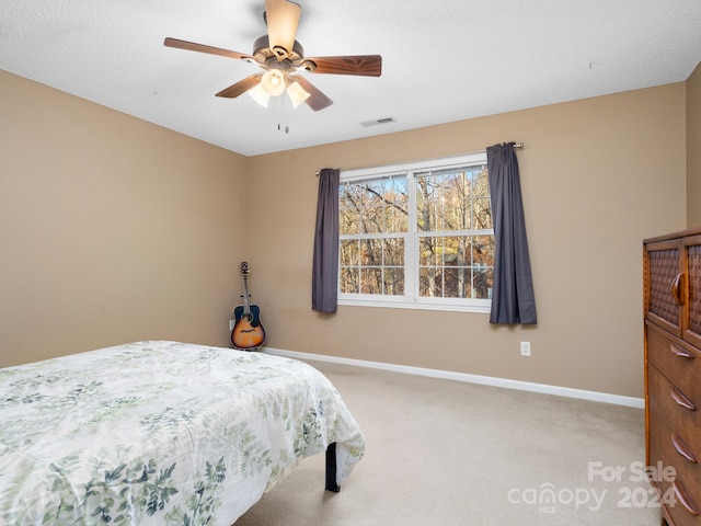 bedroom with ceiling fan and light colored carpet