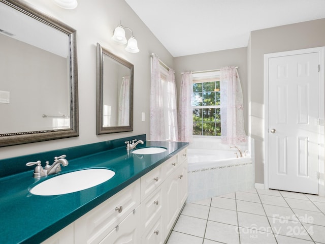 bathroom featuring tile patterned floors, tiled bath, and vanity