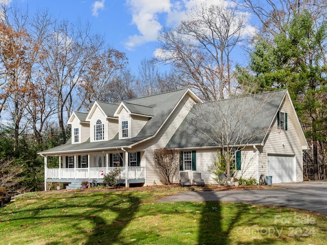 cape cod-style house with a front yard, a porch, and a garage