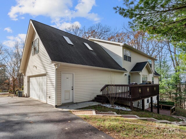 exterior space featuring a deck and a garage