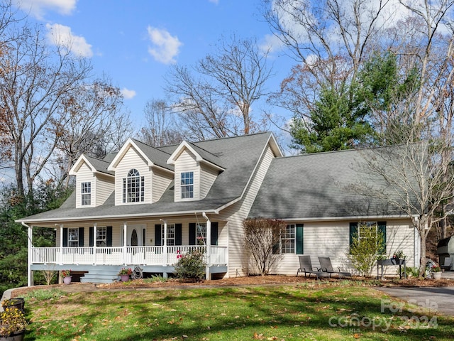 cape cod house featuring a front lawn and covered porch