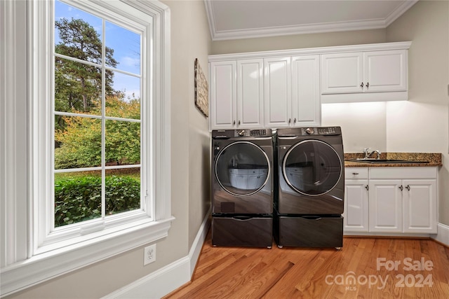 washroom featuring washer and dryer, plenty of natural light, light hardwood / wood-style floors, and sink