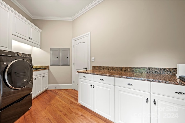 laundry area with cabinets, electric panel, light wood-type flooring, ornamental molding, and washer / clothes dryer