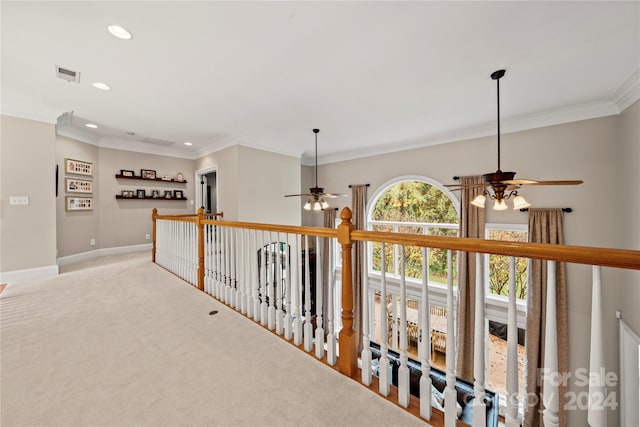 hall featuring light colored carpet and ornamental molding