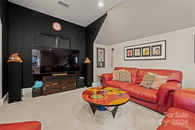 carpeted living room with lofted ceiling