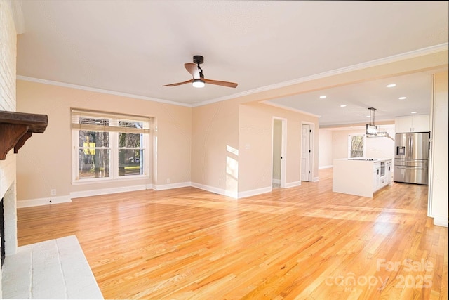 unfurnished living room with a brick fireplace, ornamental molding, light hardwood / wood-style flooring, and ceiling fan