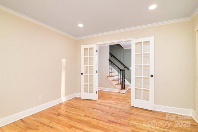 unfurnished room with hardwood / wood-style floors, ornamental molding, and french doors