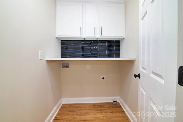 clothes washing area with light hardwood / wood-style floors, cabinets, hookup for an electric dryer, and washer hookup