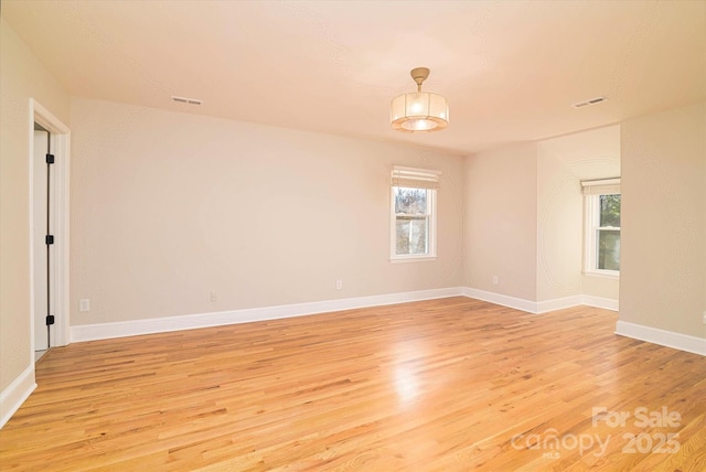 empty room featuring light hardwood / wood-style floors and a wealth of natural light