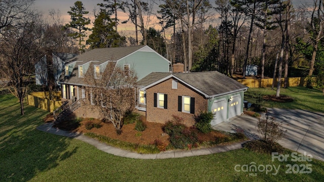 exterior space with a garage and a lawn