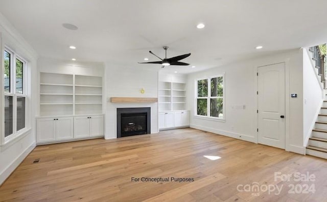 unfurnished living room featuring light hardwood / wood-style floors, ceiling fan, and a healthy amount of sunlight