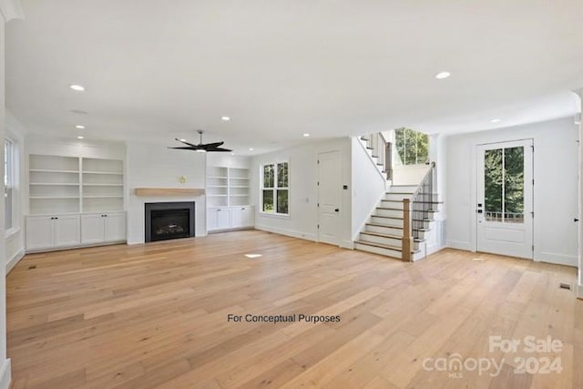 unfurnished living room featuring light hardwood / wood-style floors and ceiling fan