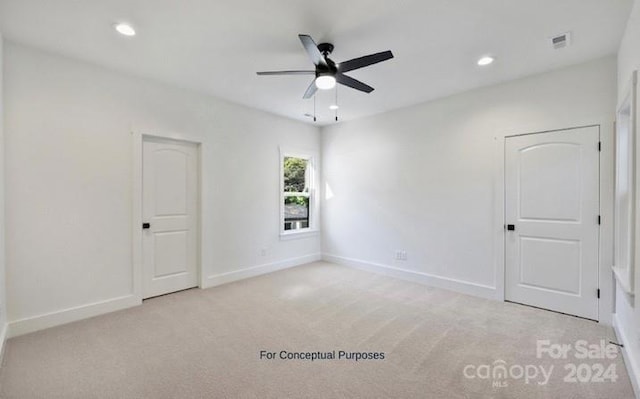 unfurnished room featuring light carpet and ceiling fan