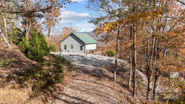 view of property exterior featuring a deck