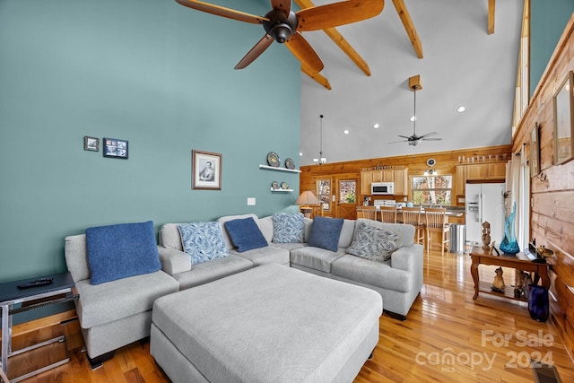 living room featuring beam ceiling, ceiling fan, high vaulted ceiling, and light hardwood / wood-style floors