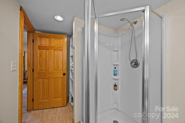 bathroom featuring wood-type flooring and walk in shower