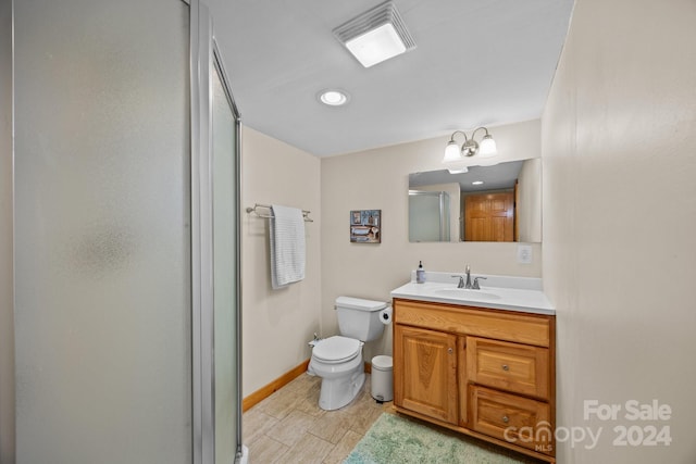 bathroom with vanity, toilet, and walk in shower