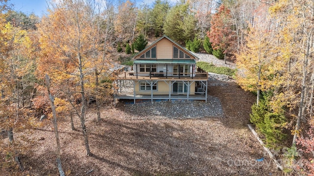 rear view of house featuring a wooden deck