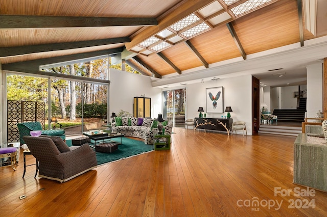 living room featuring hardwood / wood-style floors, vaulted ceiling with beams, and wood ceiling