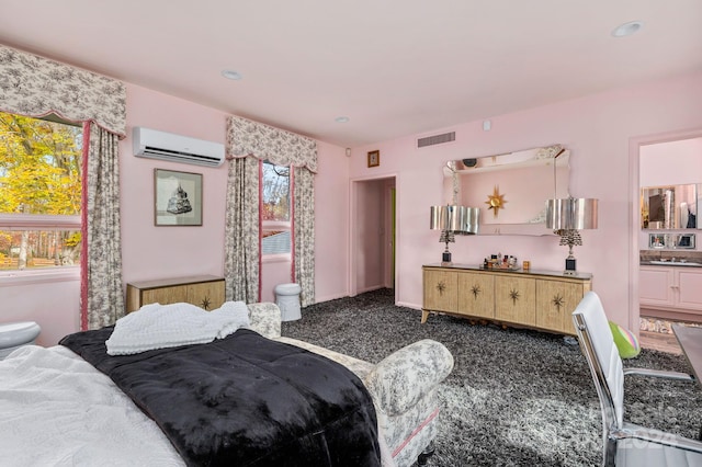 bedroom featuring a wall mounted AC and dark colored carpet