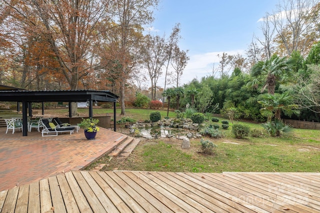 wooden terrace featuring a patio area and a yard