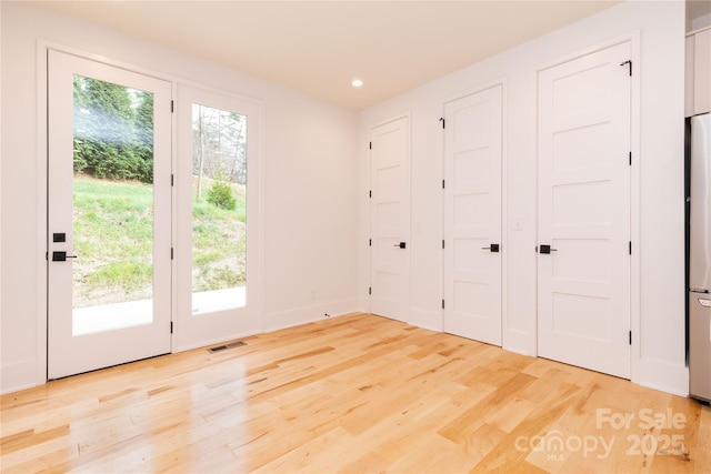 doorway to outside with light hardwood / wood-style floors