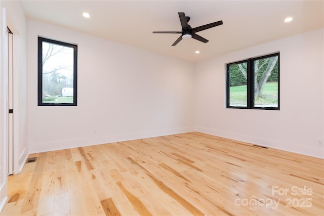 unfurnished room featuring ceiling fan and light wood-type flooring