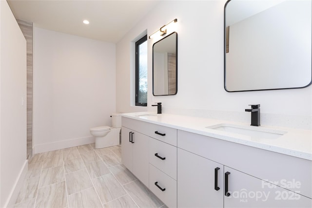 bathroom featuring vanity and toilet