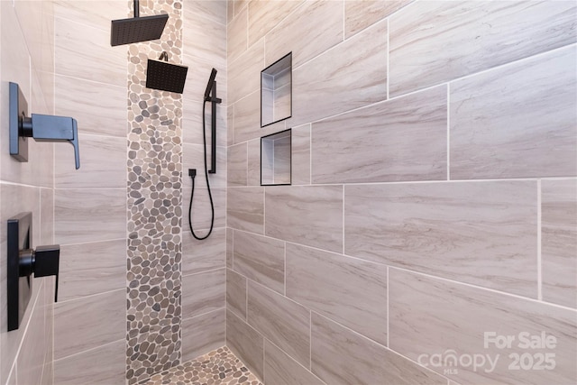 bathroom with a tile shower